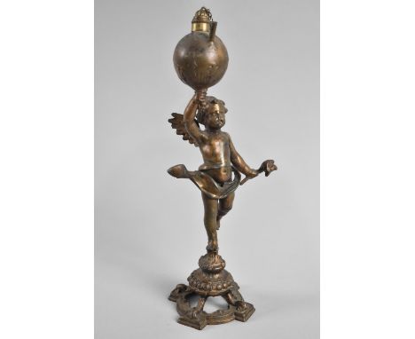 A Continental Bronzed Spelter Novelty Light in the Form of Winged Cherub Carrying Globe, 23cms High