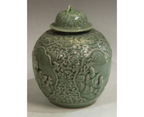 A Chinese celadon ovoid wine jar and cover, moulded in relief with four reserves of traditional figures below a ruyi frieze, 