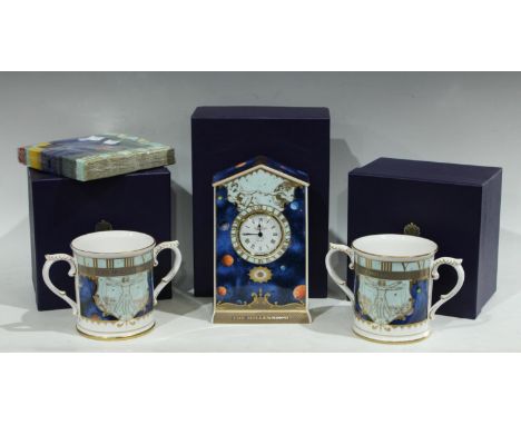 A Royal Worcester Millennium mantel clock, boxed; a pair of Royal Worcester Millennium two handled loving cups, boxed; associ