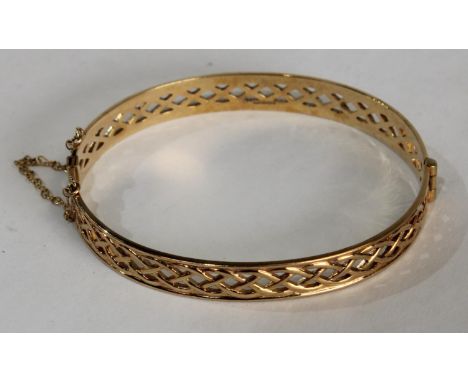 A 9ct gold pierced hinged bangle, 13g, boxed
