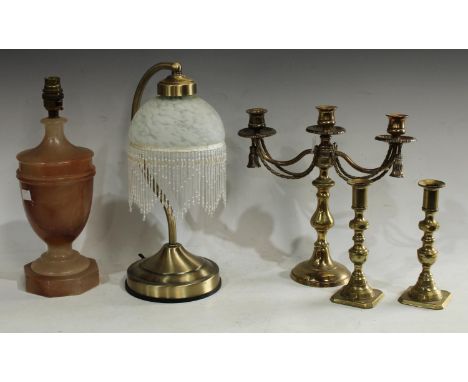 A vintage alabaster urnular table lamp; a desk lamp; a pair of brass candlesticks; a similar candelabrum