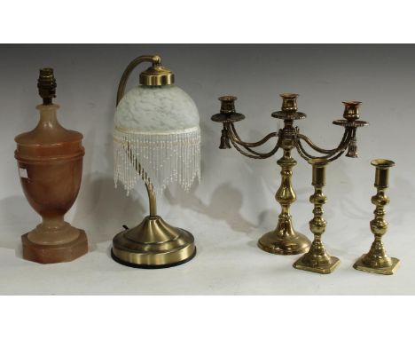 A vintage alabaster urnular table lamp; a desk lamp; a pair of brass candlesticks; a similar candelabrum