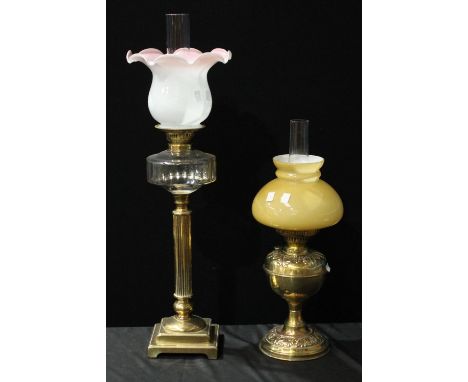 A Victorian brass and clear glass Corinthian column oil lamp, white and pink milk glass wavy rim shade, 75cm high;  another s