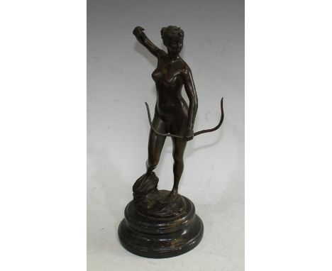 After Alexandre Falguiere a dark patinated bronze, Diana the Huntress, she stands loading her bow on a rocky outcrop, stepped