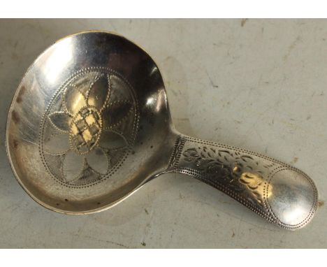 An Edwardian silver caddy spoon, of George III design, engraved overall with wrigglework, Sheffield 1911