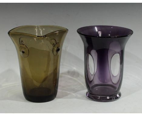 A smoky grey glass cylindrical vase, the squared top applied with four pinched roundels, 26cm; an Amethyst glass flared cylin