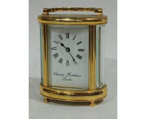 A Charles Frodsham London oval cased carriage clock, curved bevelled glass, Roman numerals, white enamelled dial, bold Roman 