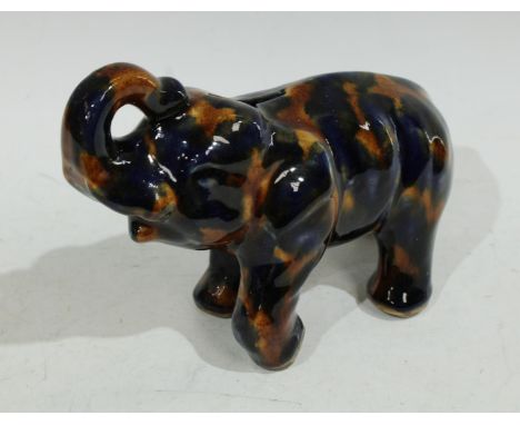 An early/mid 20th century Denby Majolica piggy bank as an Elephant, trunk raised