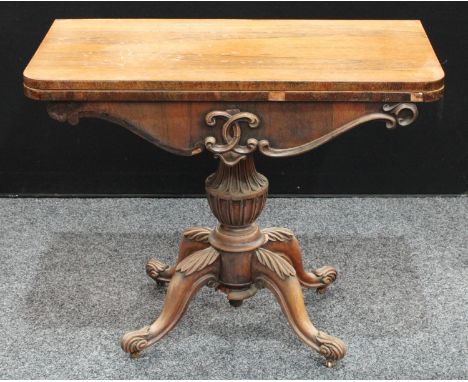 A William IV rosewood D-shaped card table, folding top enclosing an inset baize lined playing surface above a shaped frieze, 