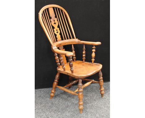 A Country House elm Windsor elbow chair, pierced splat, bowed arms terminating in scroll handrests, turned arm posts, saddle 