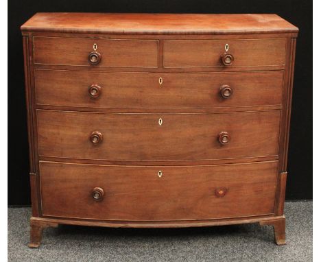 A late George III mahogany bow-front chest, slightly oversailing top above two short and three long graduated cockbeaded draw