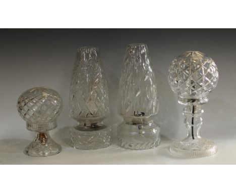 A cut glass conical table lamp, with leafy fronds and star cut lozenges, 35cm; another similar with mitre cut leaves, 35.5cm;