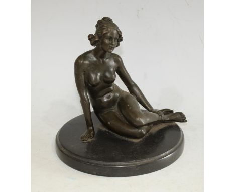 A dark patinated bronze nude, seated pensively legs to one side, her hair loosely tied, circular marble base, 17cm high, 18cm