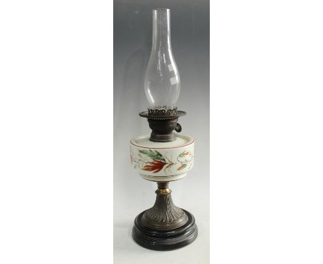 A late Victorian oil lamp, painted opaque glass reservoir, twin burner, brass base, glass chimney