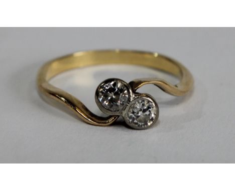 A diamond crossover twist ring, inset with two old brilliant cut diamonds, each approx 0.15ct,total estimated diamond weight 