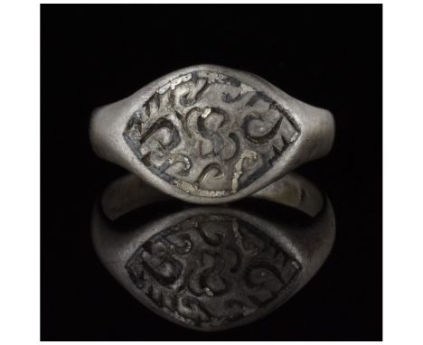 700-1100 AD, Viking Age. A silver ring with a D-shaped hoop, an elliptical bezel with incised linear and curvilinear decorati