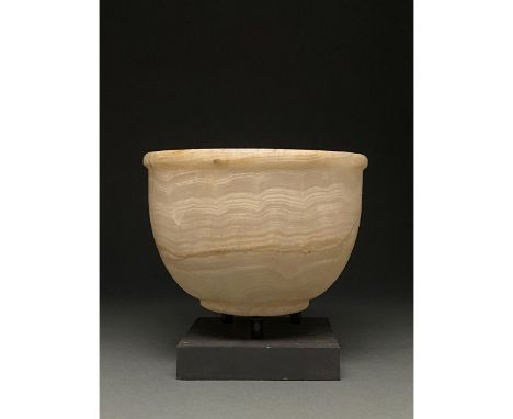 ca. 2000 BC; Egyptian. A large crème coloured steatite bowl comprising a deep squat body, a flat circular base and a thick ou