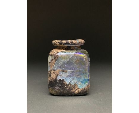 1-300 AD Roman. A beautiful light blue jar comprising a square body, a squat tubular neck, and a thick outward flexed rim. Gl
