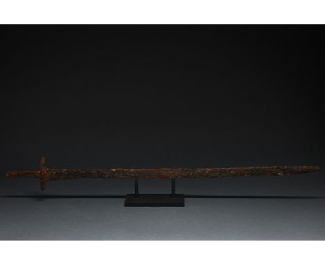 C. 600 AD. Migration Period. A long iron sword with a long, pointed, bevelled blade, a rectangular guard, and a long, rectang