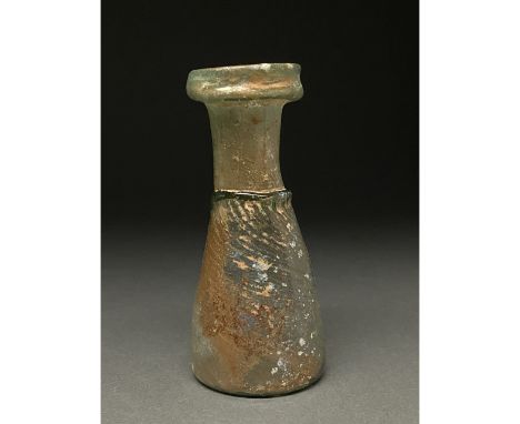Ca. 400 AD. Late Roman. An inverted conical glass flask, sometimes described as a sprinkler flask, with an applied trial half