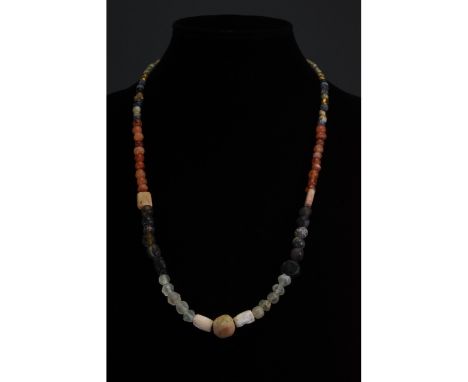 Ca. 1-300 AD. Roman. A restrung necklace of Roman beads comprising multiple opaque and transparent sub-spherical, tubular, cu