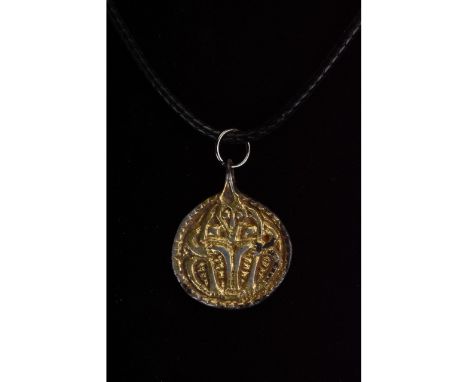 C. 700-1100. Viking Age. Gilded silver amulet featuring a disc shape with an integral suspension loop. The central section de