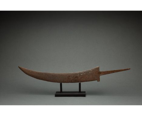 c. 1400 AD. Medieval Persian. Iron sword or large dagger, with curved blade, protruding rectangular guard, and flaring tang. 