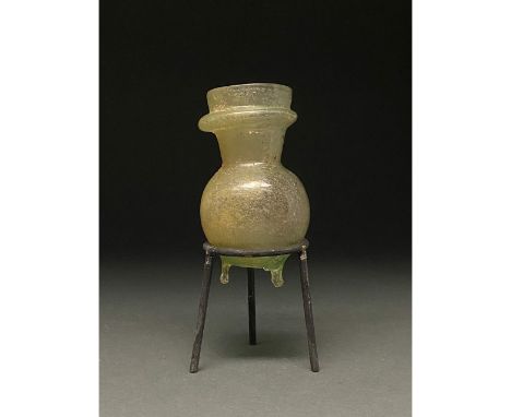 1-300 AD Roman. A beautiful light green jar comprising a globular body, a short flaring neck with double outurned rims, and t