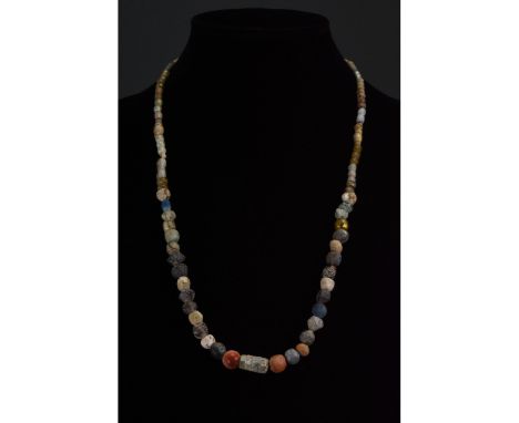 Ca. 1-300 AD. Roman. A restrung necklace of Roman beads comprising multiple opaque and transparent sub- spherical, tubular an