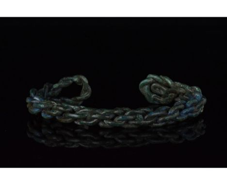 700-1100 AD, Viking Age. A heavy silver twisted bracelet comprised strands of silver woven together, with looped terminals me