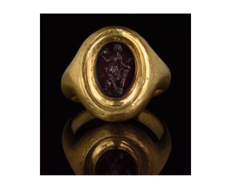 1-200 AD. Roman. Gold ring with D-shaped hoop, stepped, elliptical bezel and carnelian intaglio depicting a standing Diana, h