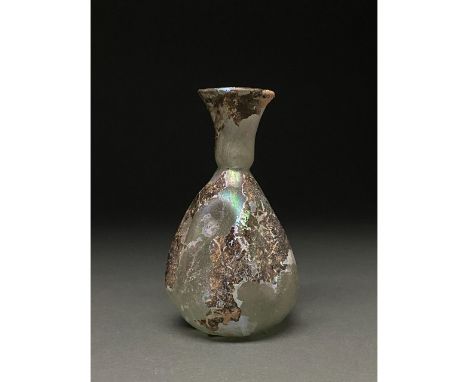Ca. 1-300 AD Roman. A beautiful light green flask with a long, outward flaring neck, rounded rim, and a flaring globular body