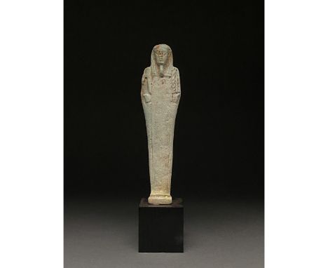 Ca.1070-945 BC Egyptian. Beautiful light blue faience ushabti figure wearing a tripartite wig, a false beard and holding a tw