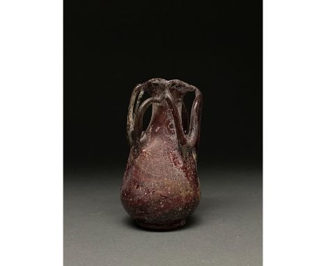 c.400 AD Roman. A beautiful aubergine glass flask comprising a rounded globular body, a long straight neck, and a flaring, ou