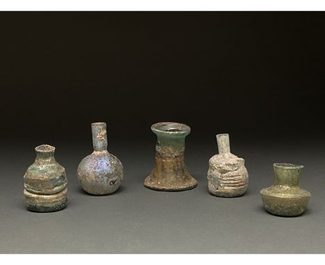 Ca. 1-400 AD. Roman and Late Roman. A lot of five blown glass vessels, comprising (L-R): A squat jar with a flaring neck and 