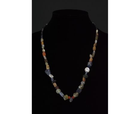 Ca. 1-300 AD. Roman. A restrung necklace of Roman beads comprising multiple opaque and transparent sub- spherical, tubular an