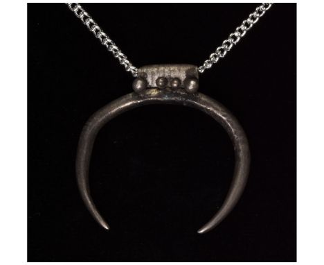 Ca. 100 AD, Roman. Wonderful lunar amulet comprising a crescent moon with a wide banded suspension loop. In Roman mythology, 