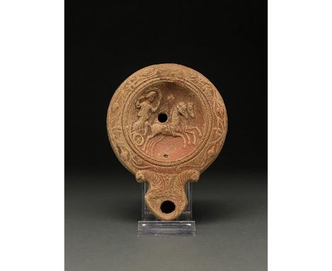 Ca. 1-300 AD. Roman. A beautiful ceramic lamp depicting a female charioteer, possibly Selene goddess of the moon driving a te