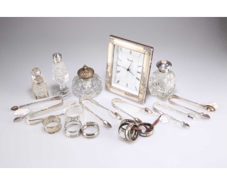 A GROUP OF SILVER AND PLATE, including six pairs of Georgian and later silver tea tongs, Harrods silver-mounted clock, sterli