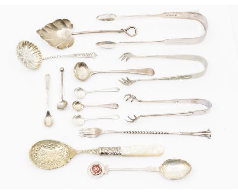 A quantity of silver flatware to include: mustard spoons, sugar sifter, leaf shaped condiment spoon, pickle fork, sugar nippe