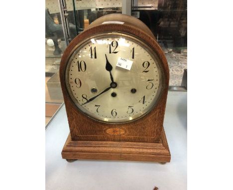 A dome shaped mahogany Edwardian mantle clock, eight day, with chime, Arabic numerals, batwing inlay detail
