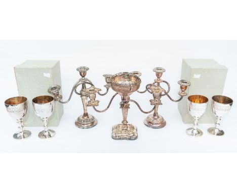 A pair of Victorian style candelabra together with another similar, all with twist stems and ornate drip pans and nozzles, th