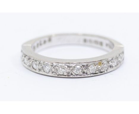 A diamond and 18ct white gold half eternity ring, grain set to the front with eight cut diamonds, width approx 3mm, size K, t