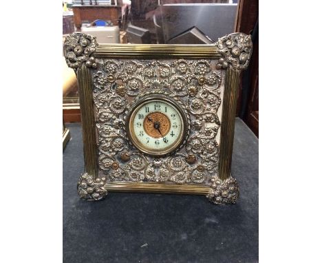 A late 19th Century plated easel mantle clock, with threat work detail, Arabic numerals, leather backed with stand, in workin