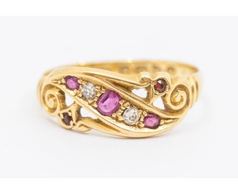 A Victorian ruby and diamond 18ct gold ring scrolled open work set with round cut rubies and diamond accents, size N, total g