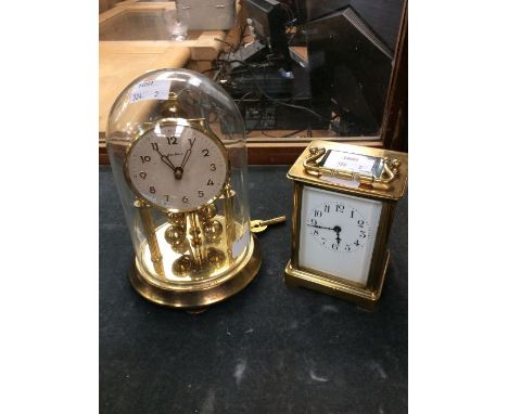 An early 20th Century brass French carriage clock, AF, along with a mid 20th Century anniversary clock in dome