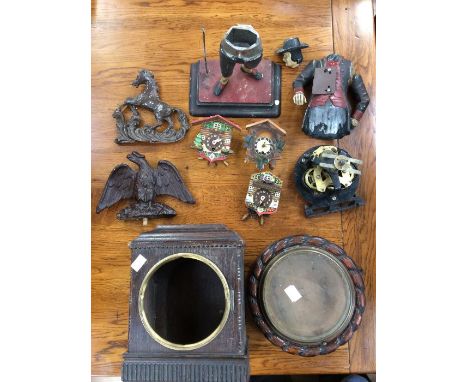 1. Three miniature cuckoo clocks A.F.2. Peddler's clock, broken and incomplete A.F.3. Vienna horse and eagle and face mask4. 