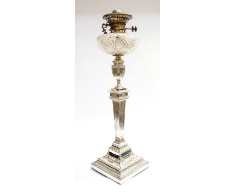 An Edwardian large table oil lamp, hobnail cut bulbous reservoir above Sheffield plate Neo-Classical column stand in the mann