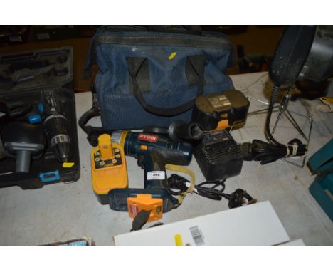 A Ryobi power tools bag together with a cordless drill charger and two batteries