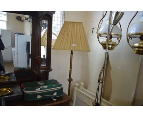 A brass standard lamp and shade 